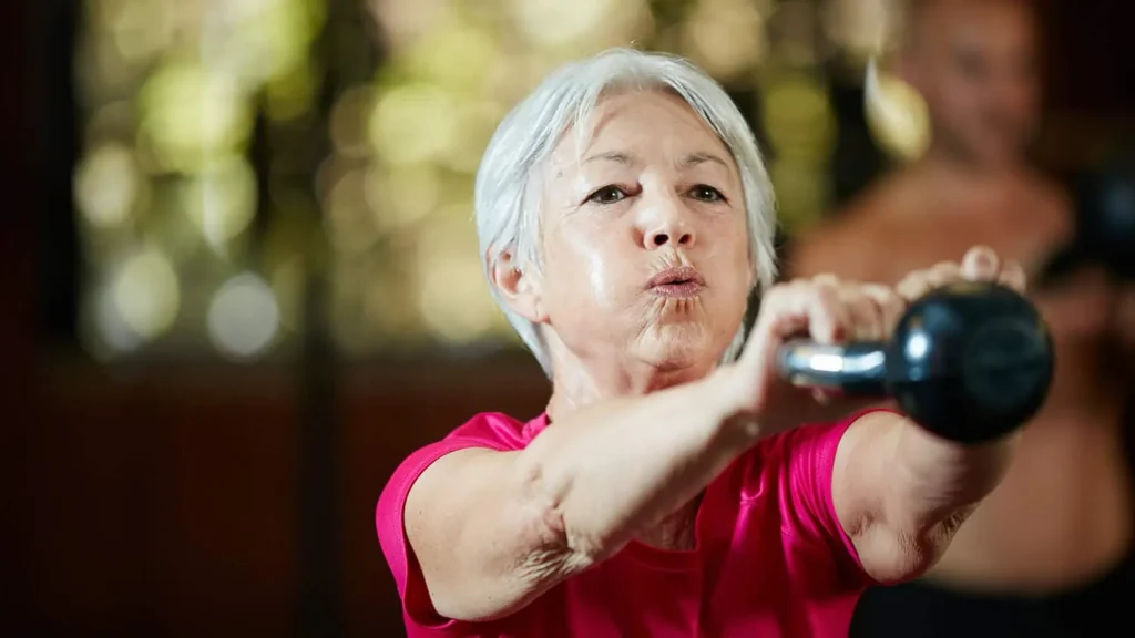 Toning Bingo Wings: Effective Exercises and Tips for Achieving Sleeker Arms 2 Person performing arm exercises with dumbbells East Kilbride